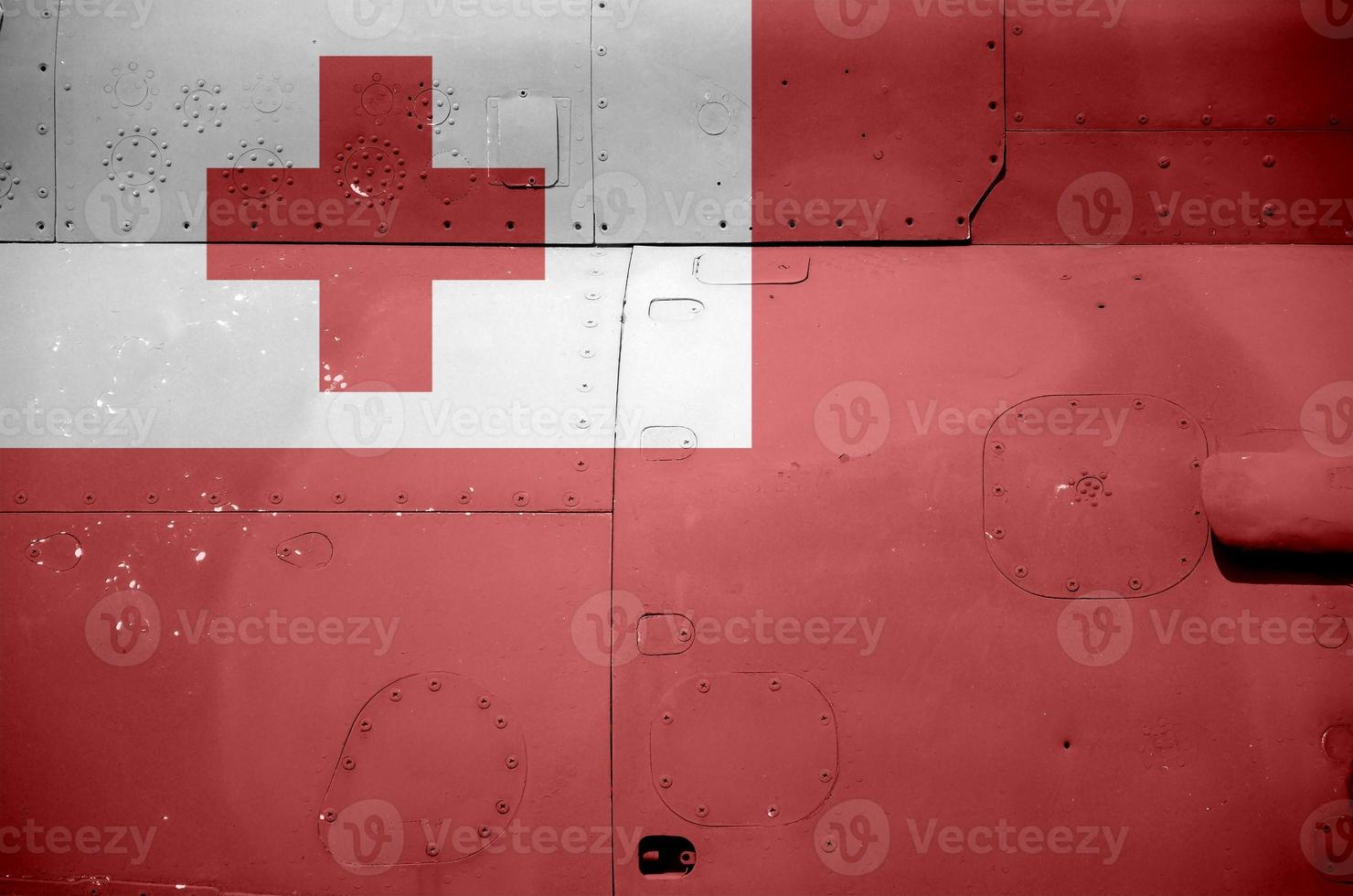 Tonga flag depicted on side part of military armored helicopter closeup. Army forces aircraft conceptual background photo