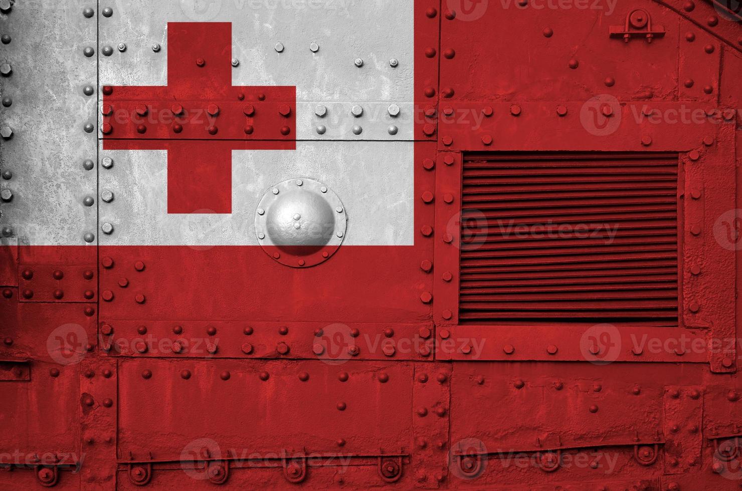 Tonga flag depicted on side part of military armored tank closeup. Army forces conceptual background photo
