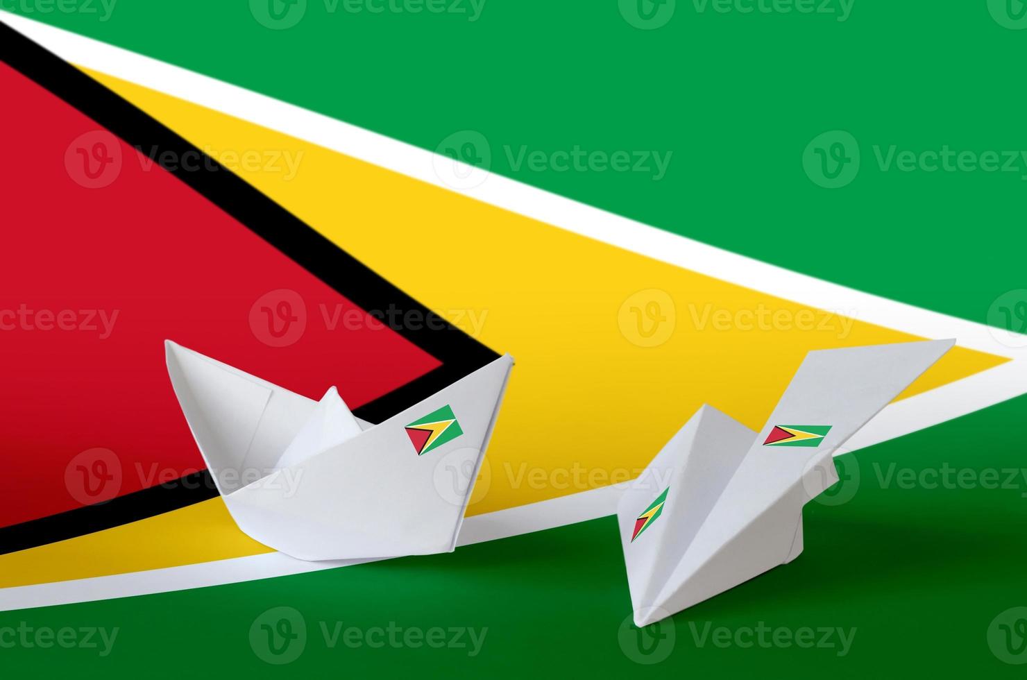 Guyana flag depicted on paper origami airplane and boat. Handmade arts concept photo