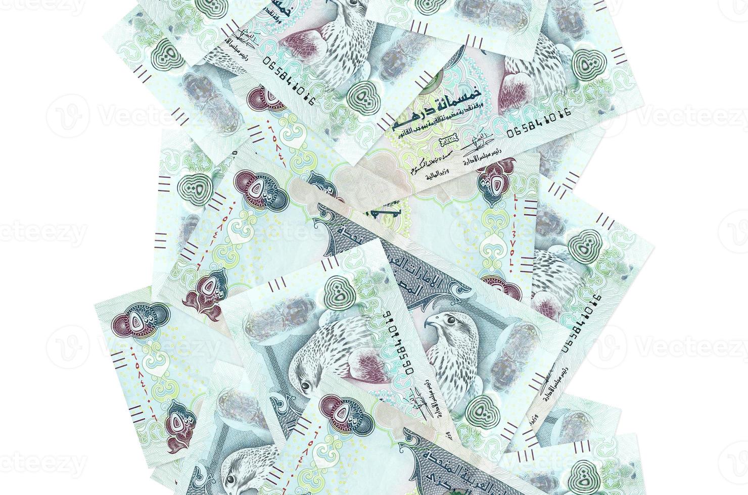 500 UAE dirhams bills flying down isolated on white. Many banknotes falling with white copyspace on left and right side photo