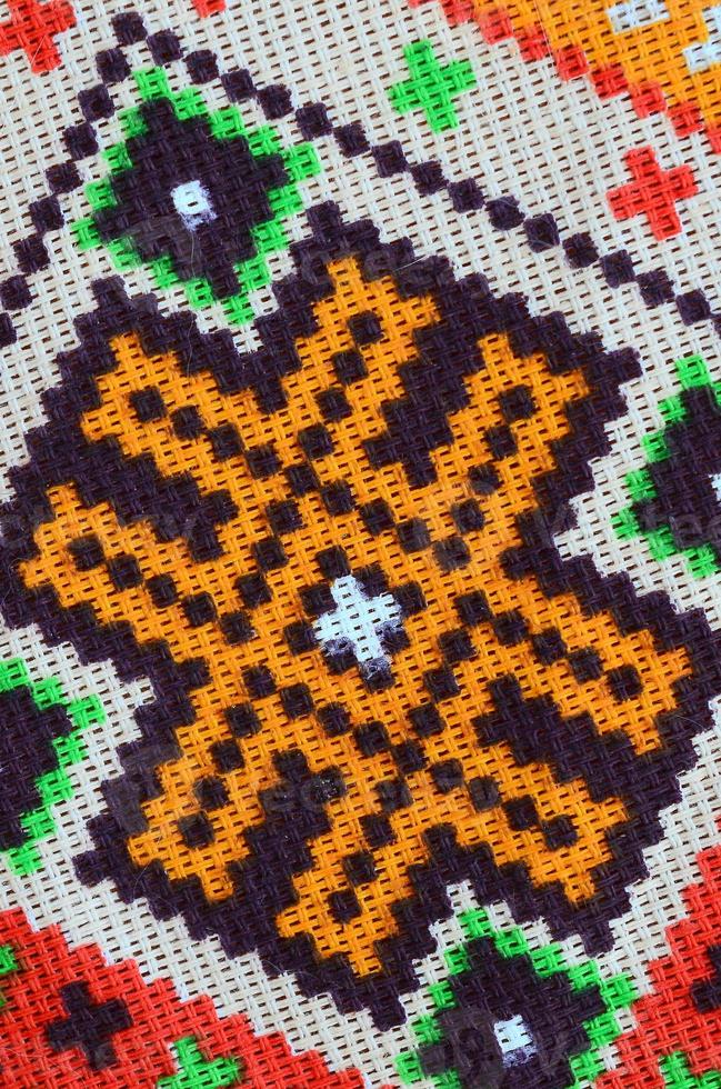 Traditional Ukrainian folk art knitted embroidery pattern on textile fabric photo