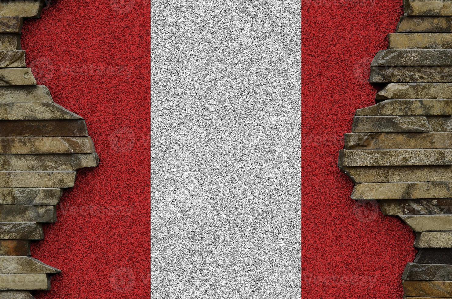 Peru flag depicted in paint colors on old stone wall closeup. Textured banner on rock wall background photo