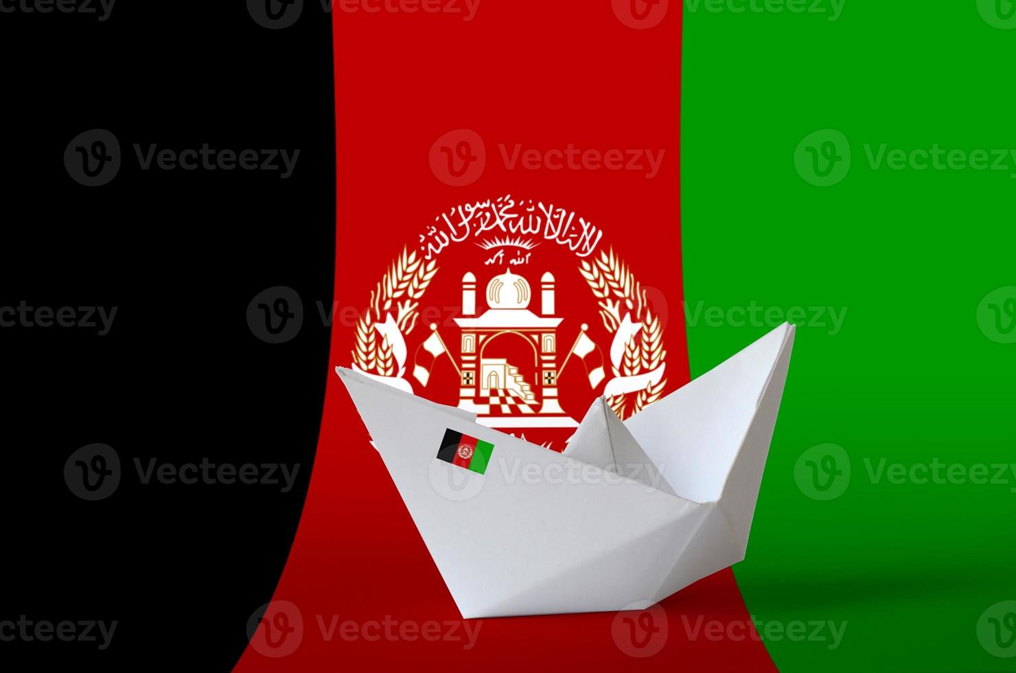 Afghanistan flag depicted on paper origami ship closeup. Handmade arts concept photo