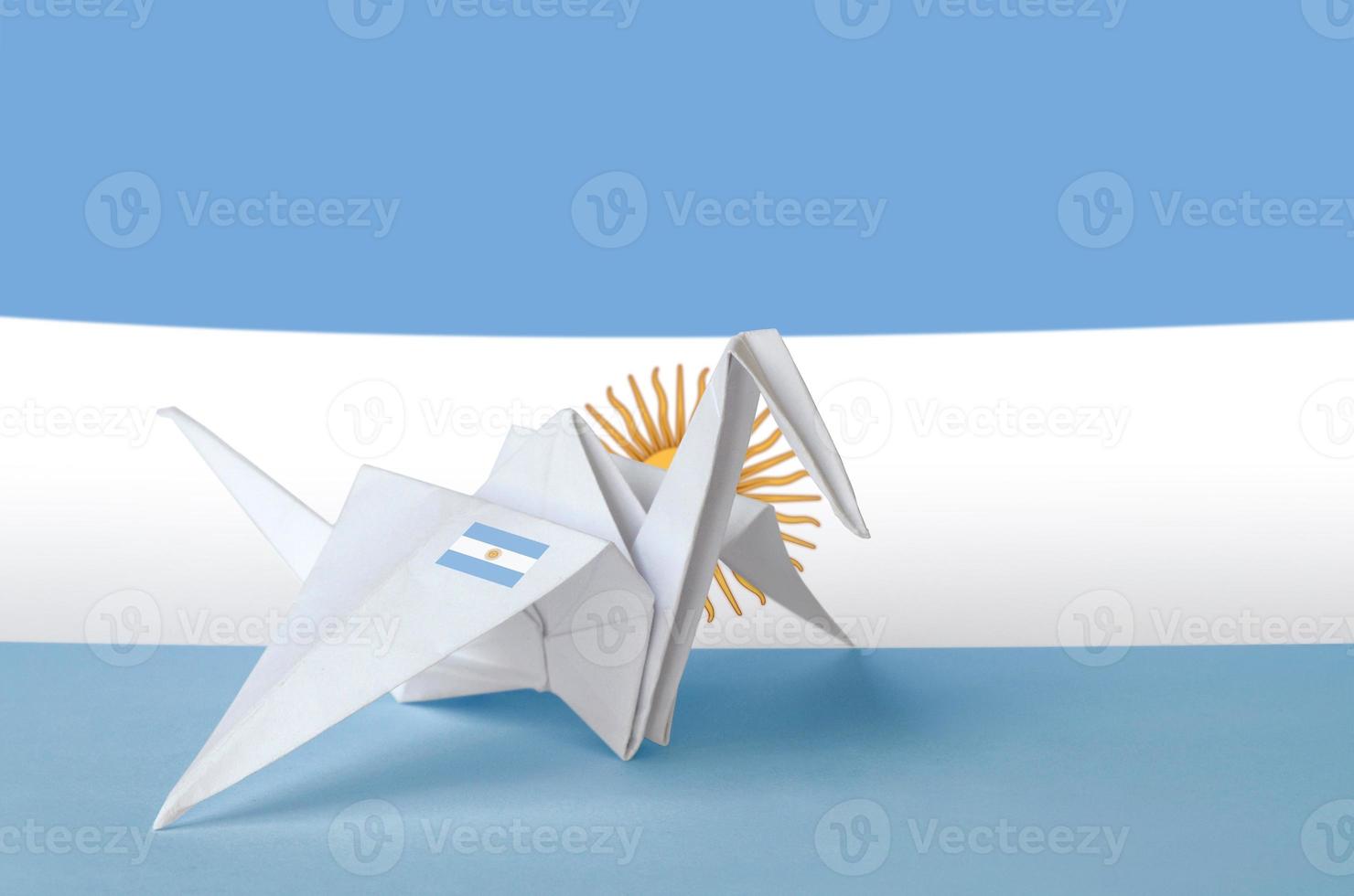Argentina flag depicted on paper origami crane wing. Handmade arts concept photo