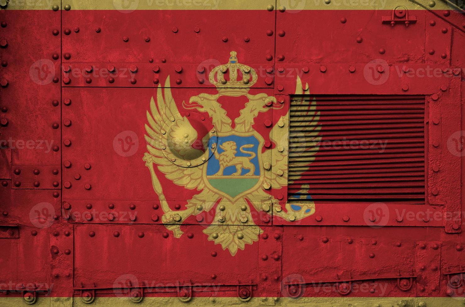 Montenegro flag depicted on side part of military armored tank closeup. Army forces conceptual background photo