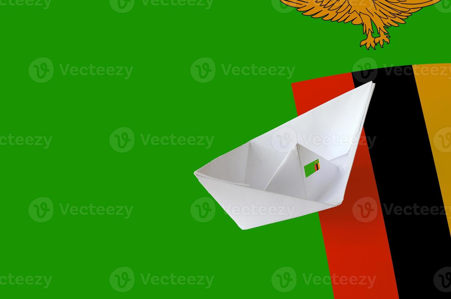 Zambia flag depicted on paper origami ship closeup. Handmade arts concept photo