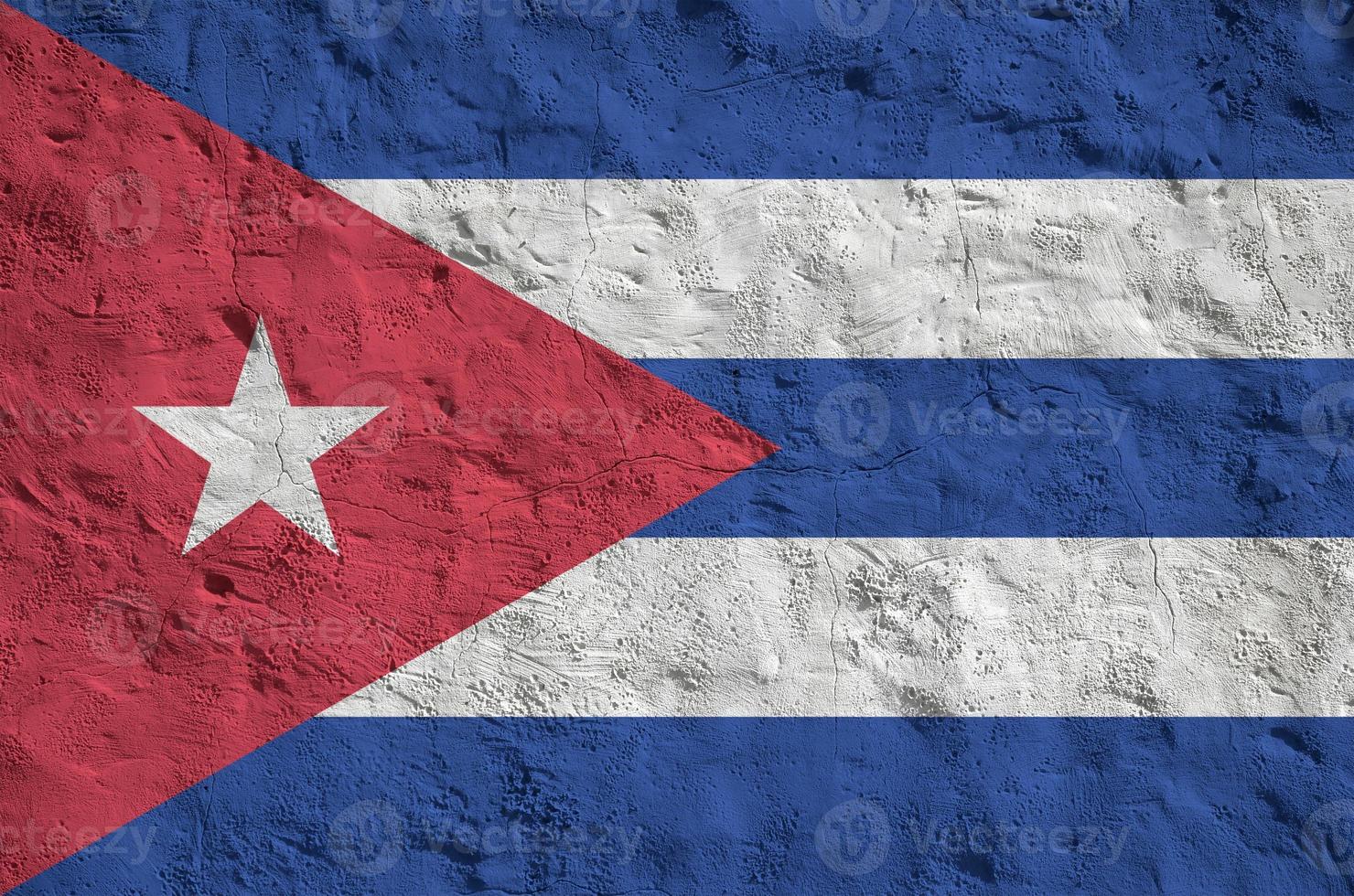 Cuba flag depicted in bright paint colors on old relief plastering wall. Textured banner on rough background photo