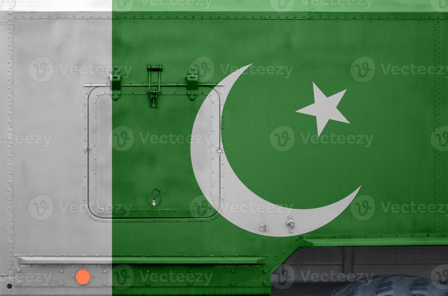 Pakistan flag depicted on side part of military armored truck closeup. Army forces conceptual background photo