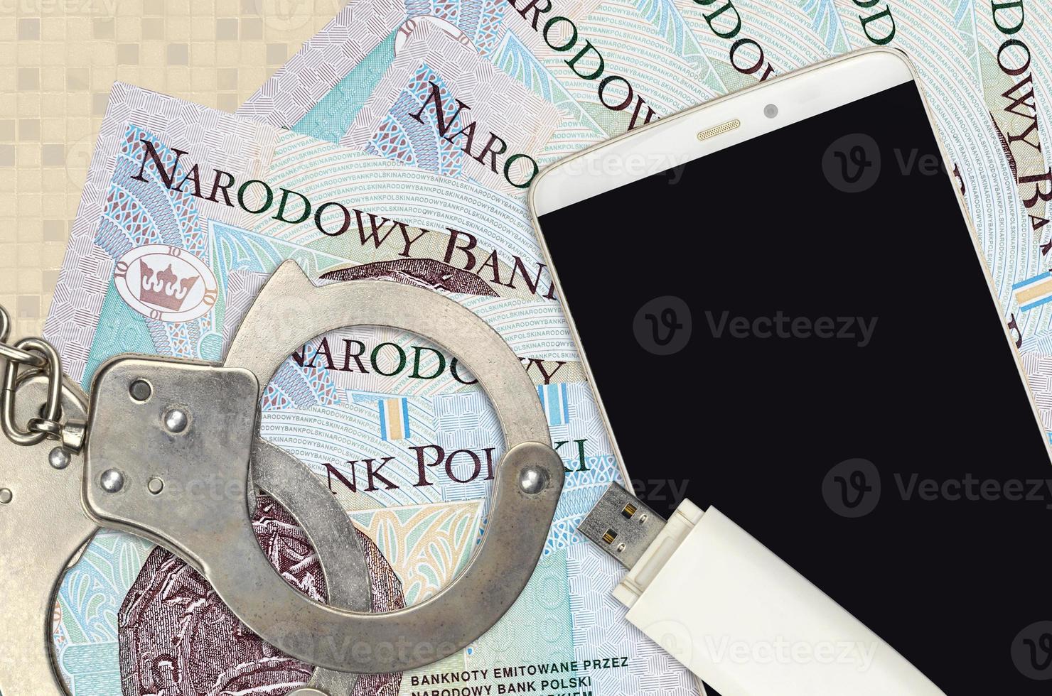 10 Polish zloty bills and smartphone with police handcuffs. Concept of hackers phishing attacks, illegal scam or malware soft distribution photo