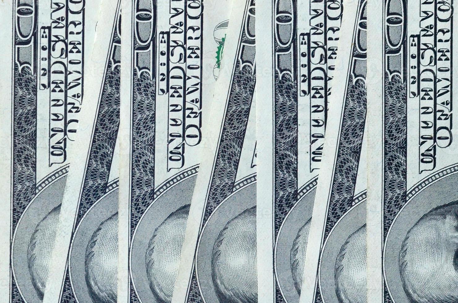 Abstract backdrop with many hundred dollar bills close up photo