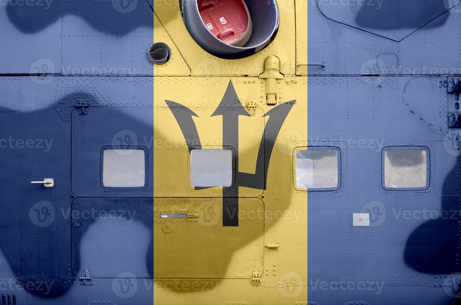 Barbados flag depicted on side part of military armored helicopter closeup. Army forces aircraft conceptual background photo