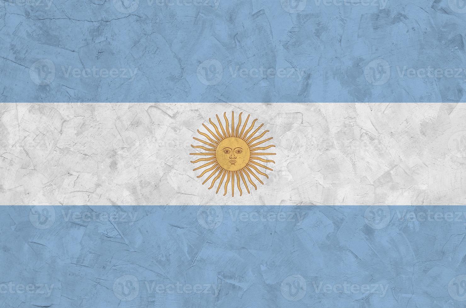 Argentina flag depicted in bright paint colors on old relief plastering wall. Textured banner on rough background photo