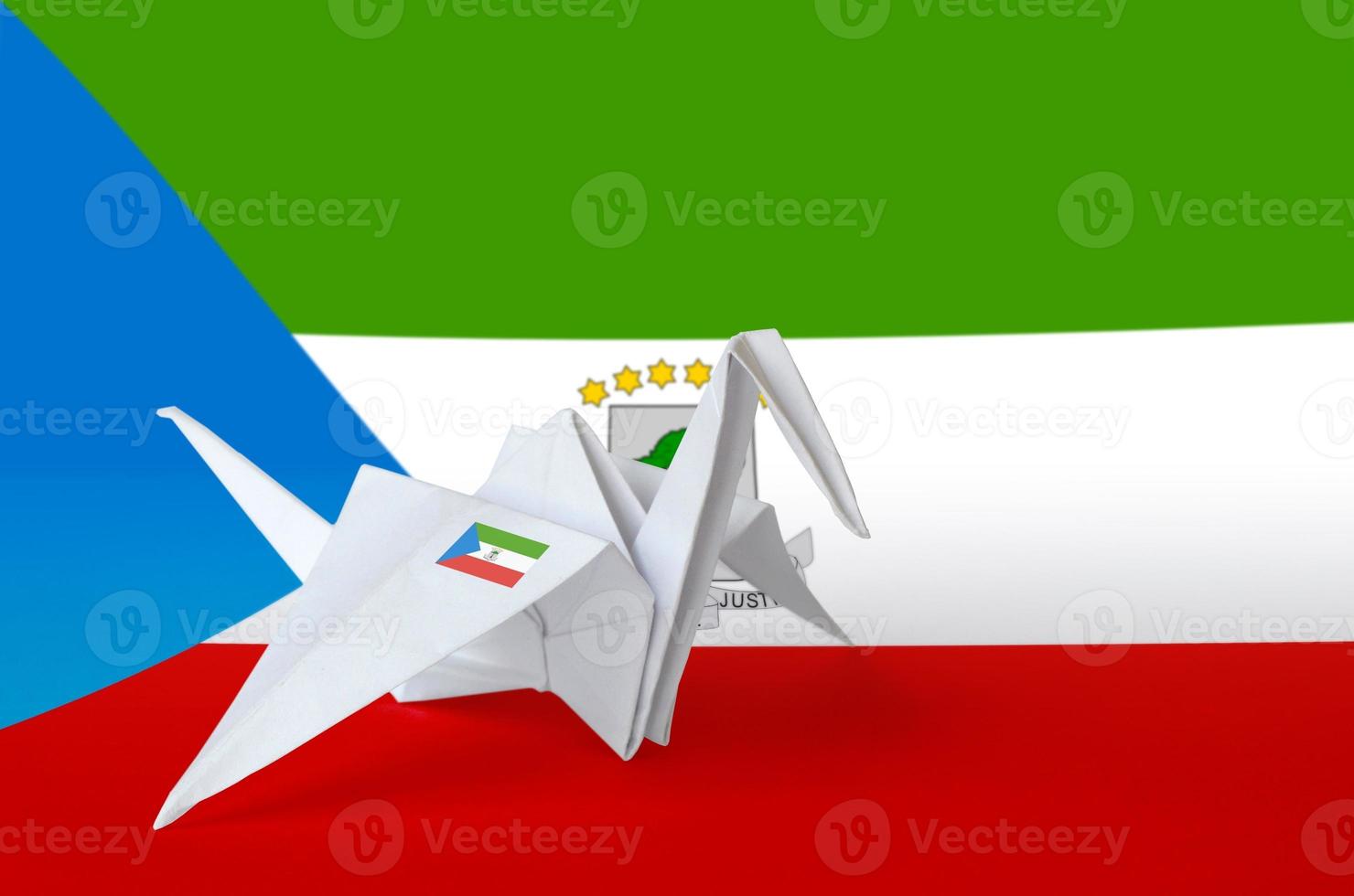 Equatorial Guinea flag depicted on paper origami crane wing. Handmade arts concept photo