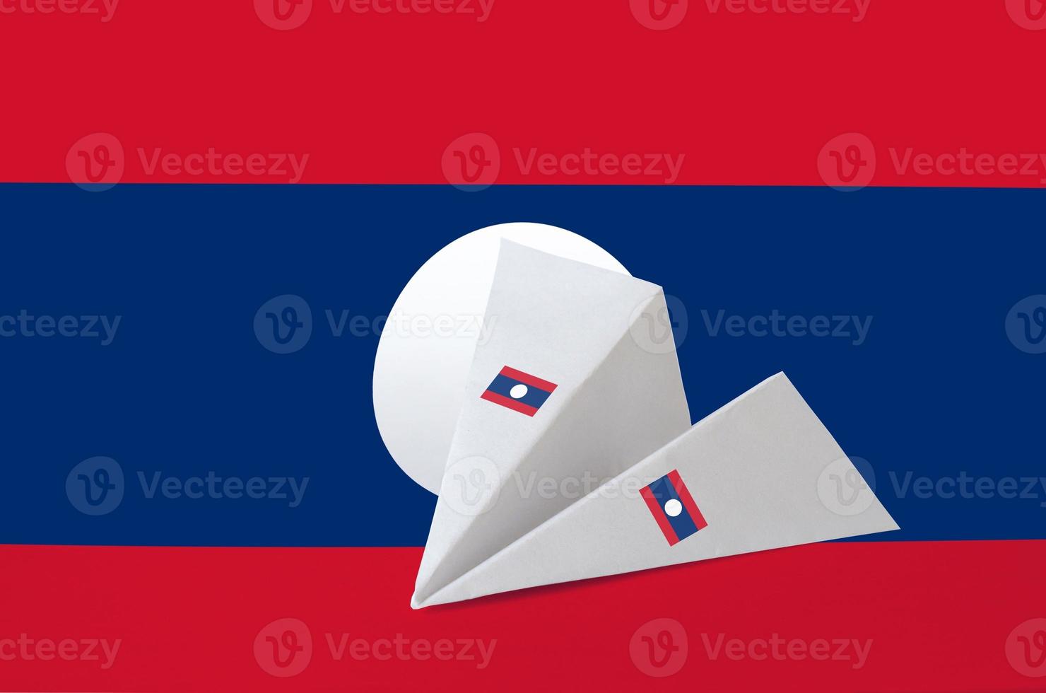 Laos flag depicted on paper origami airplane. Handmade arts concept photo