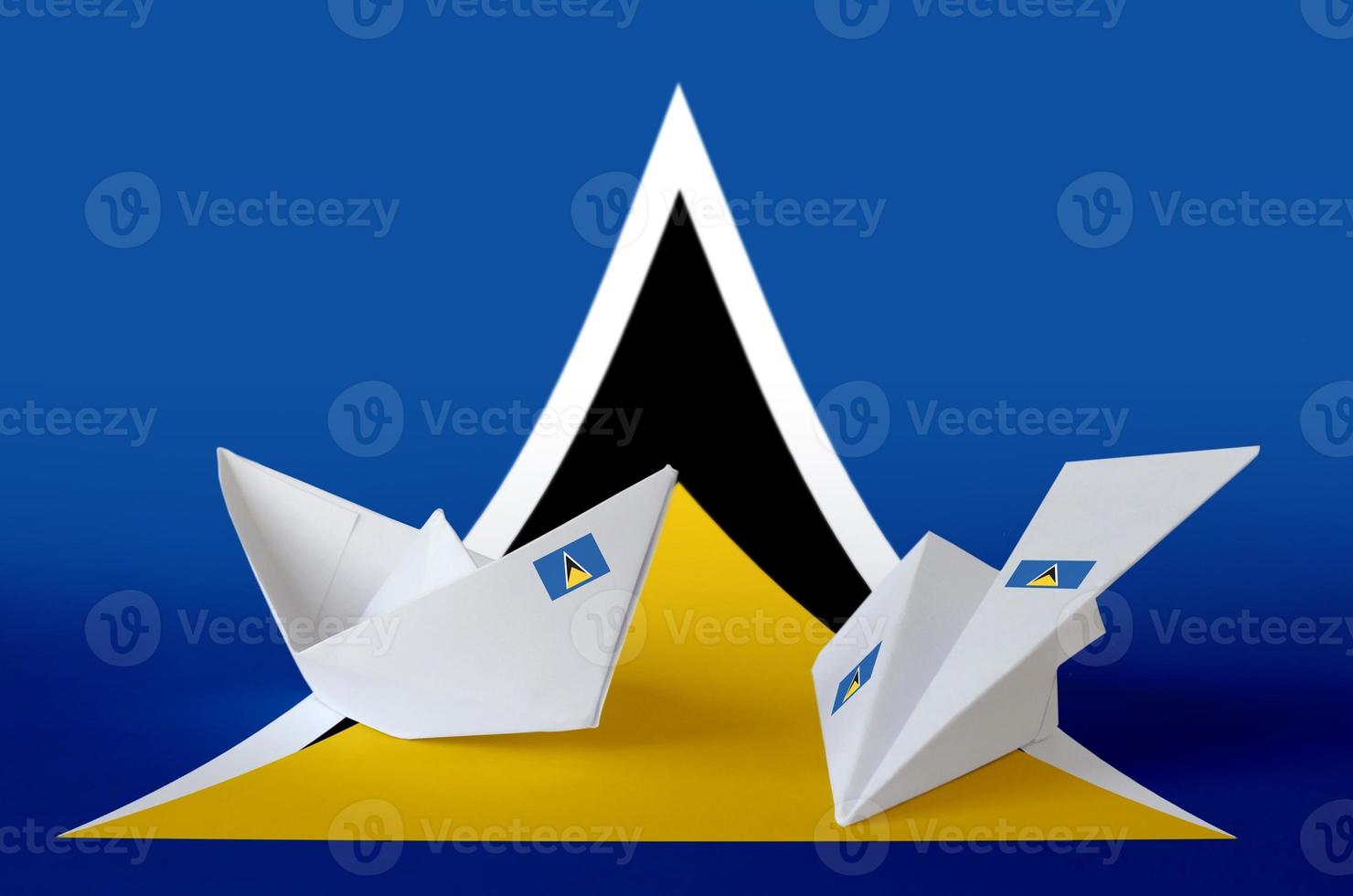 Saint Lucia flag depicted on paper origami airplane and boat. Handmade arts concept photo