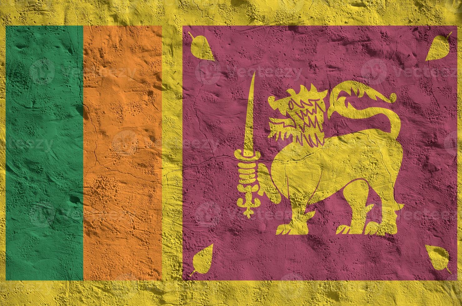 Sri Lanka flag depicted in bright paint colors on old relief plastering wall. Textured banner on rough background photo