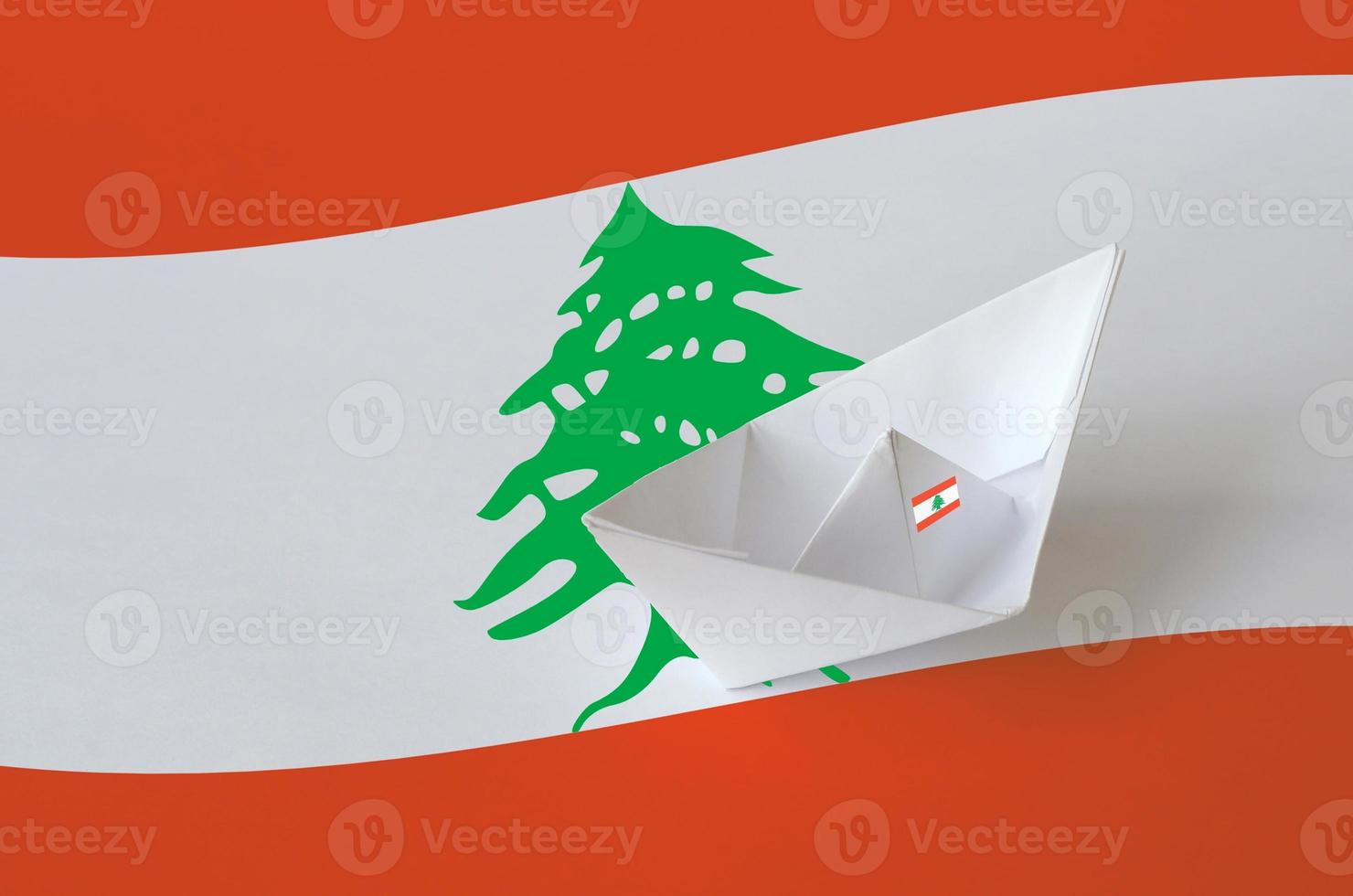 Lebanon flag depicted on paper origami ship closeup. Handmade arts concept photo