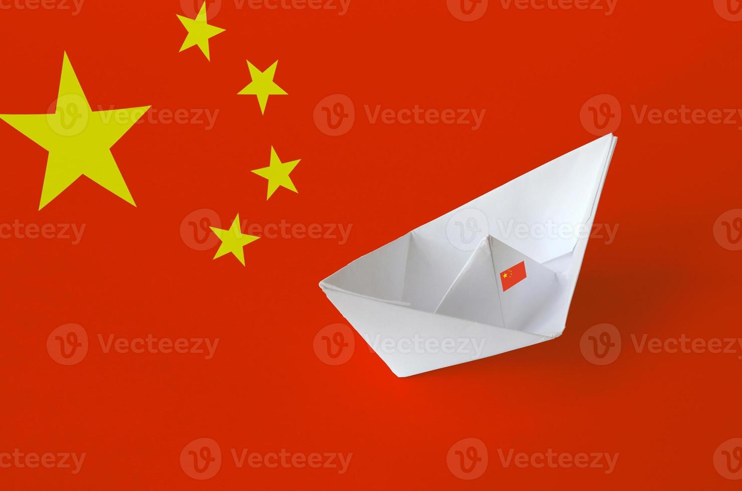 China flag depicted on paper origami ship closeup. Handmade arts concept photo