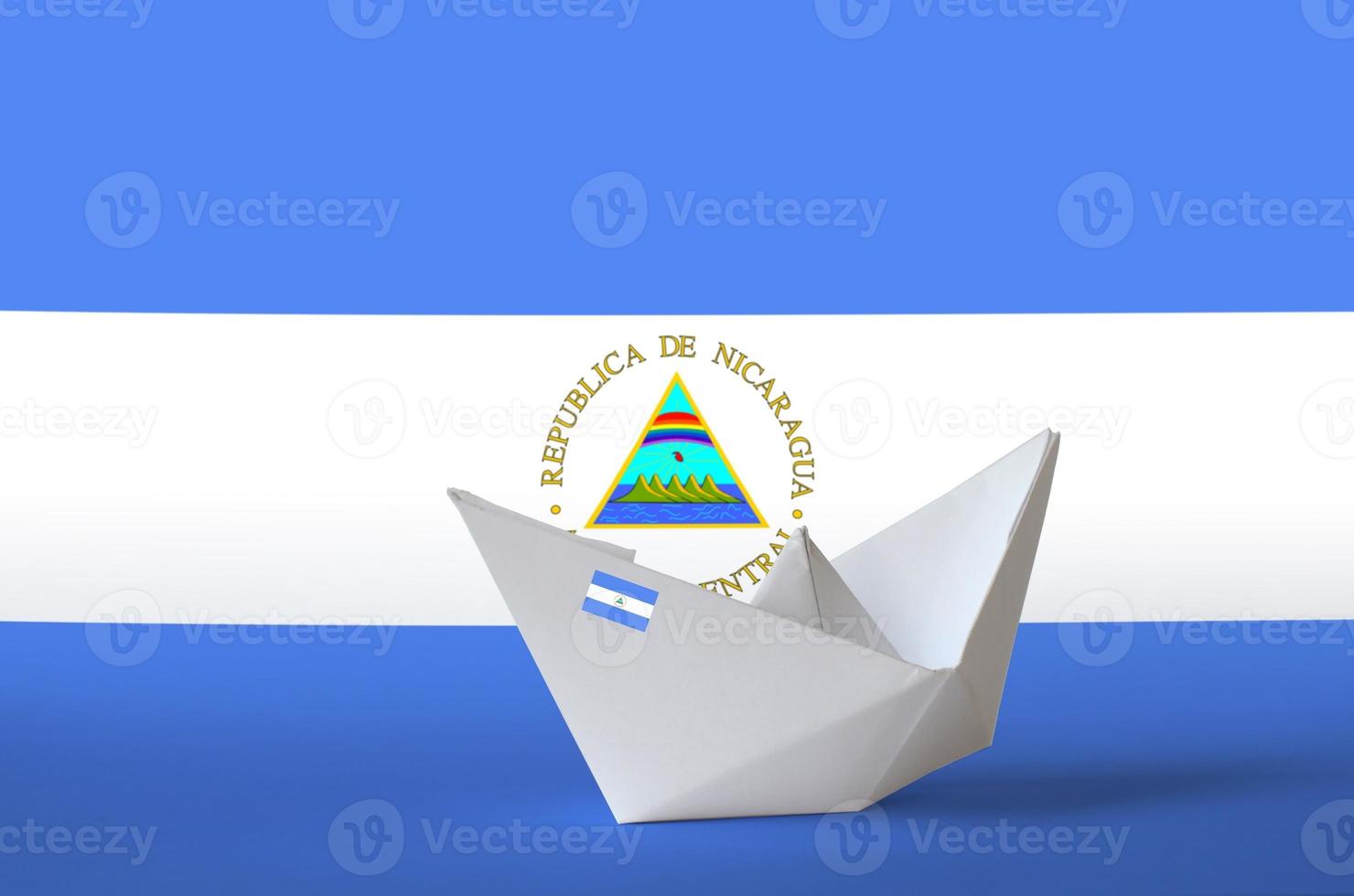 Nicaragua flag depicted on paper origami ship closeup. Handmade arts concept photo