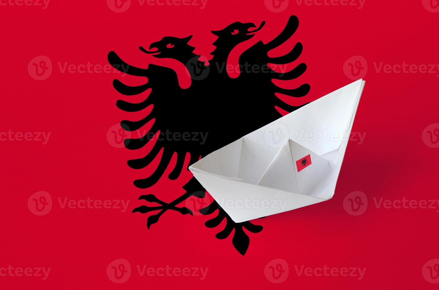 Albania flag depicted on paper origami ship closeup. Handmade arts concept photo