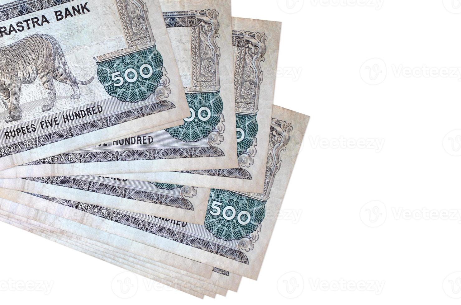 500 Nepalese rupees bills lies in small bunch or pack isolated on white. Mockup with copy space. Business and currency exchange photo