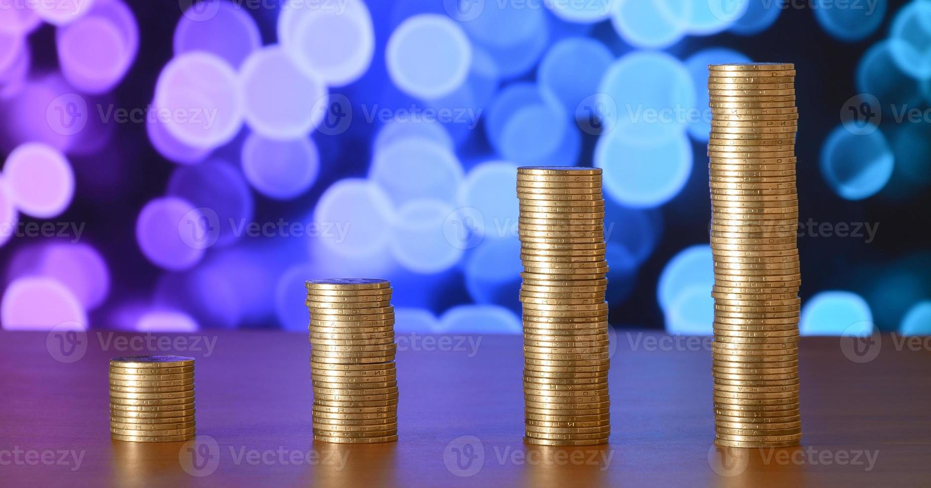 Golden coin stacks arranged as a graph. Increasing columns of coins photo