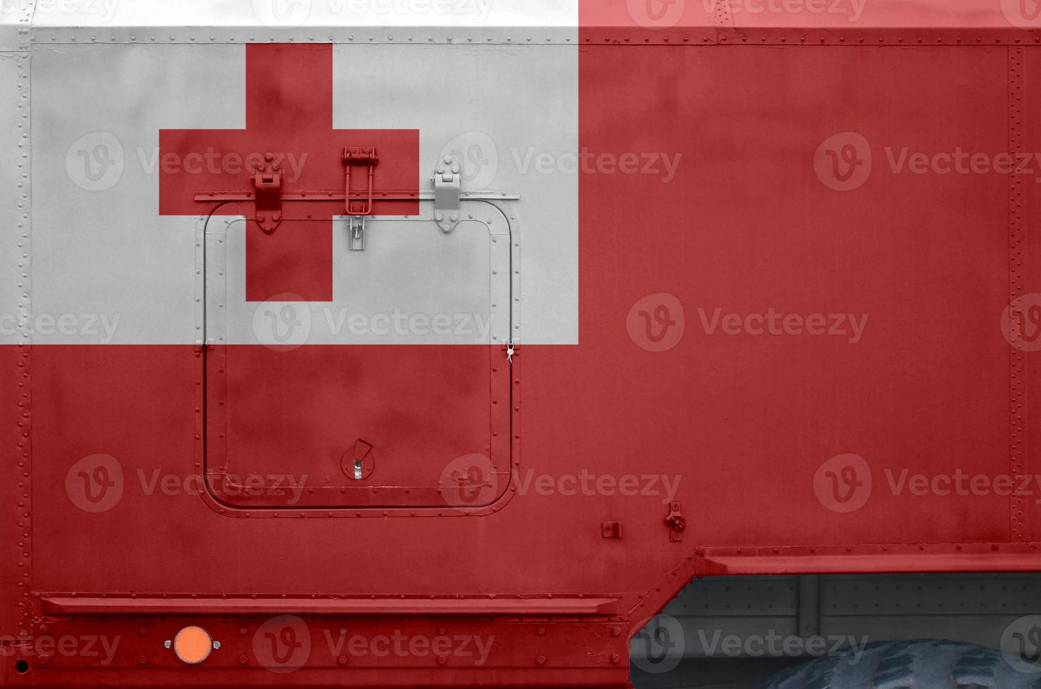Tonga flag depicted on side part of military armored truck closeup. Army forces conceptual background photo