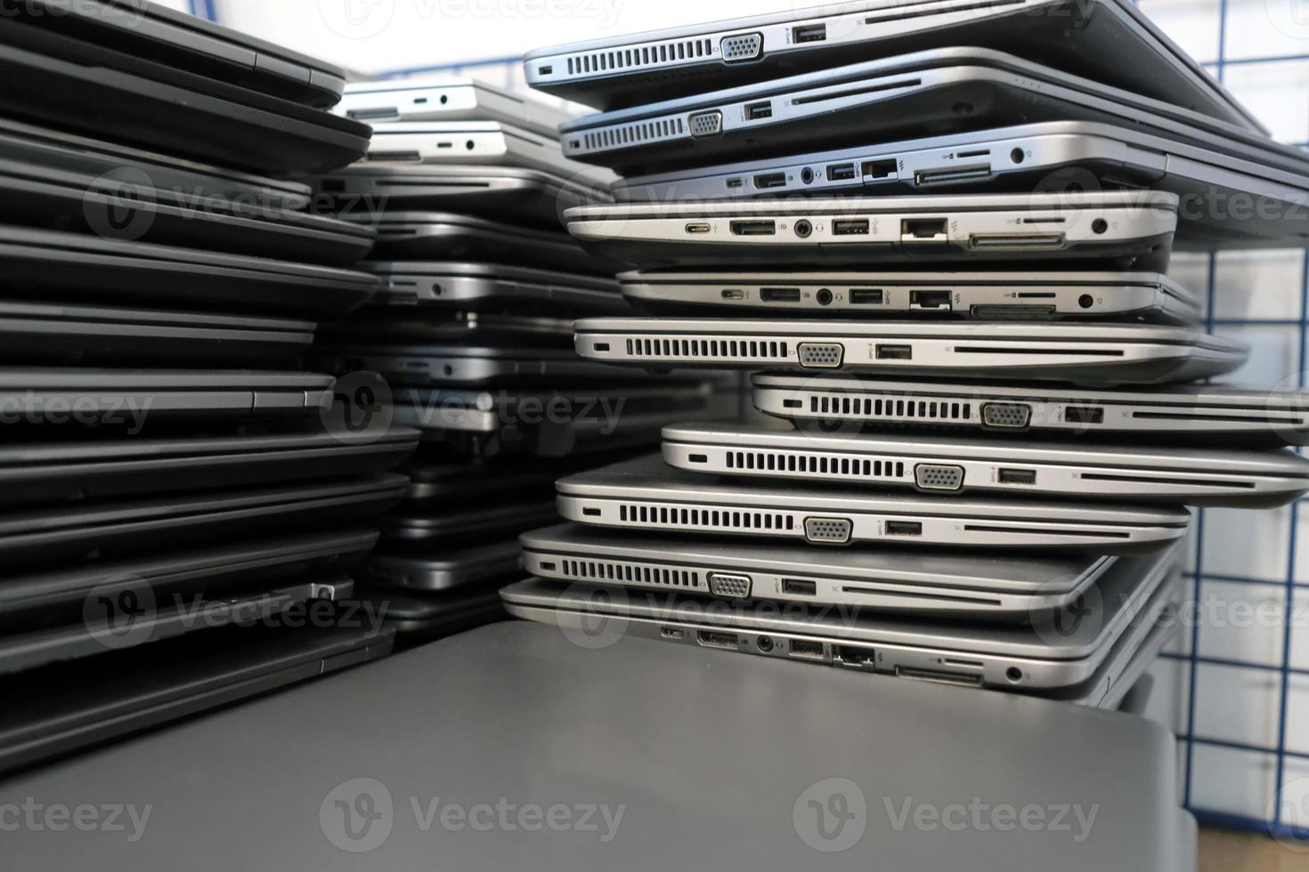 Big stacks of discarded laptops, notebooks on a trolley photo