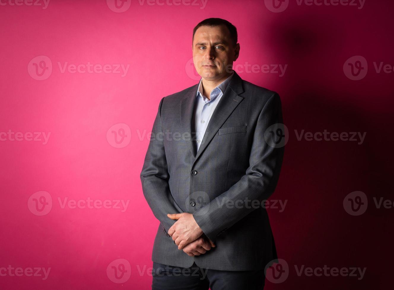 handsome businessman in a suit looks at the camera. photo