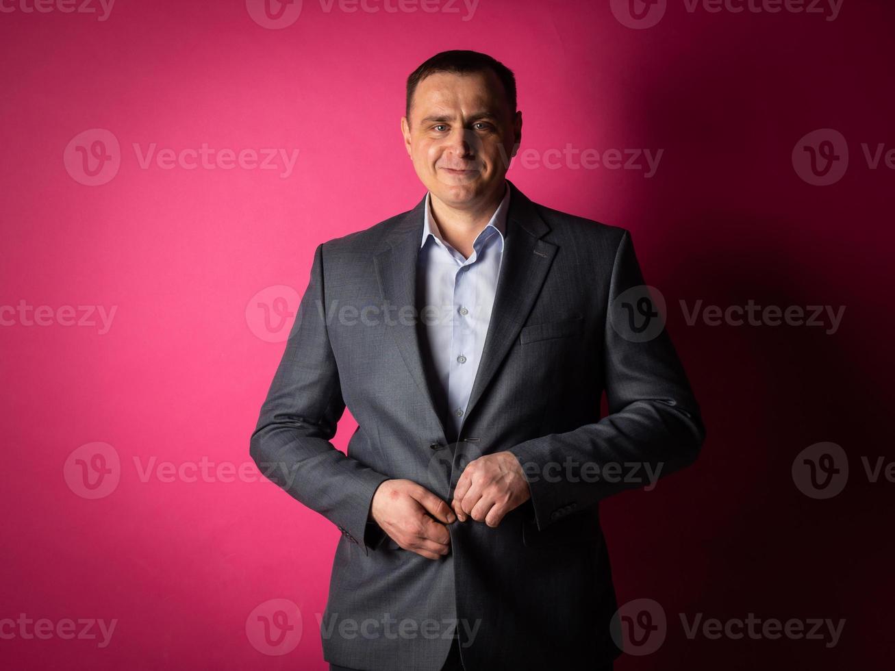 handsome businessman in a suit looks at the camera. photo