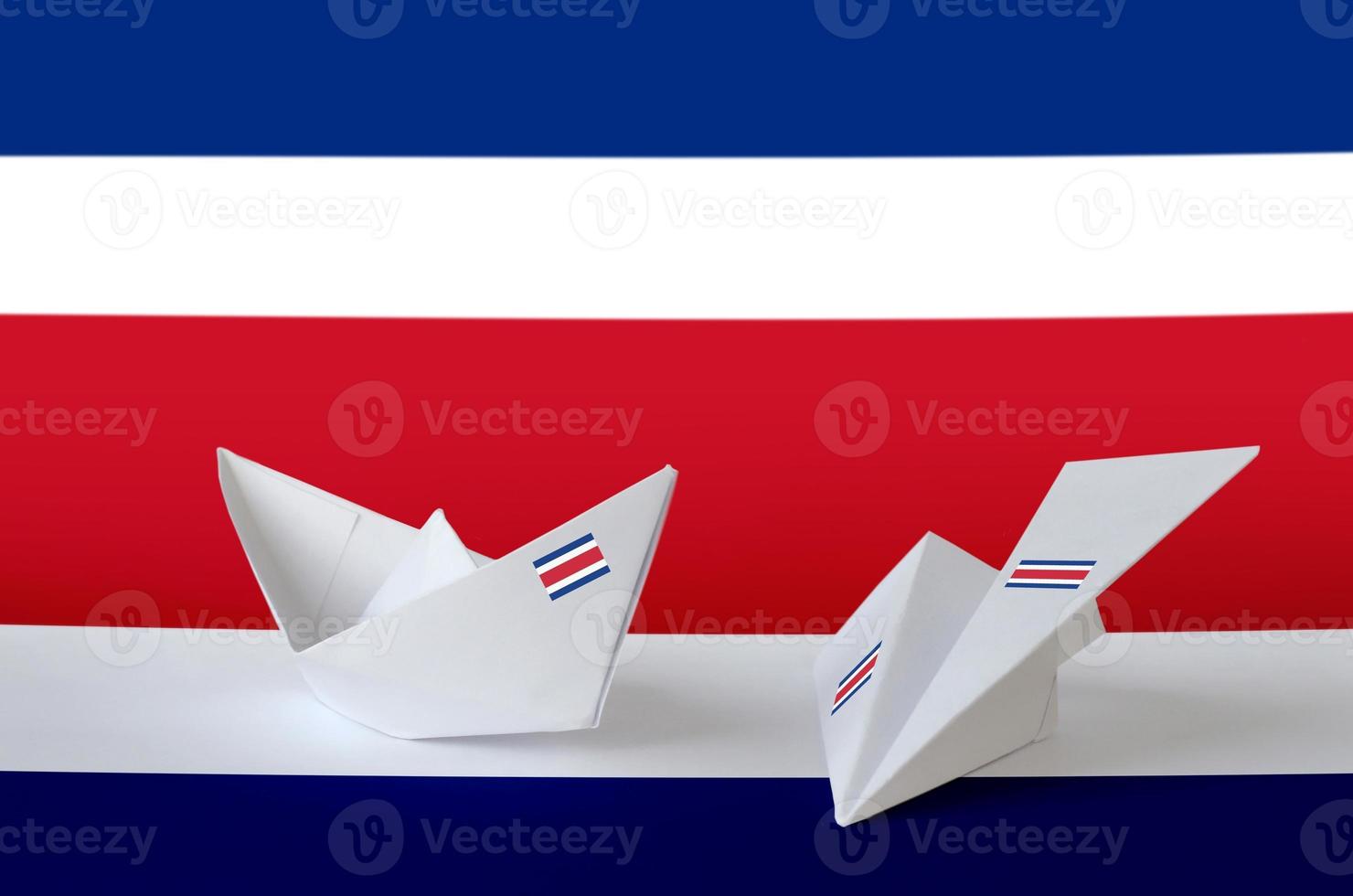 Costa Rica flag depicted on paper origami airplane and boat. Handmade arts concept photo