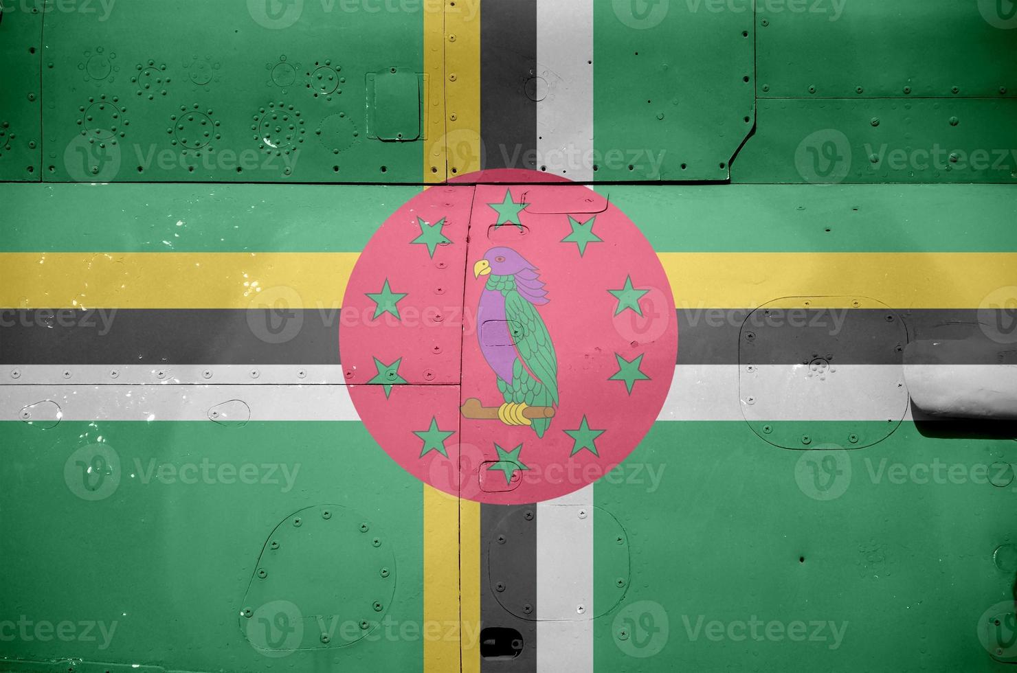 Dominica flag depicted on side part of military armored helicopter closeup. Army forces aircraft conceptual background photo