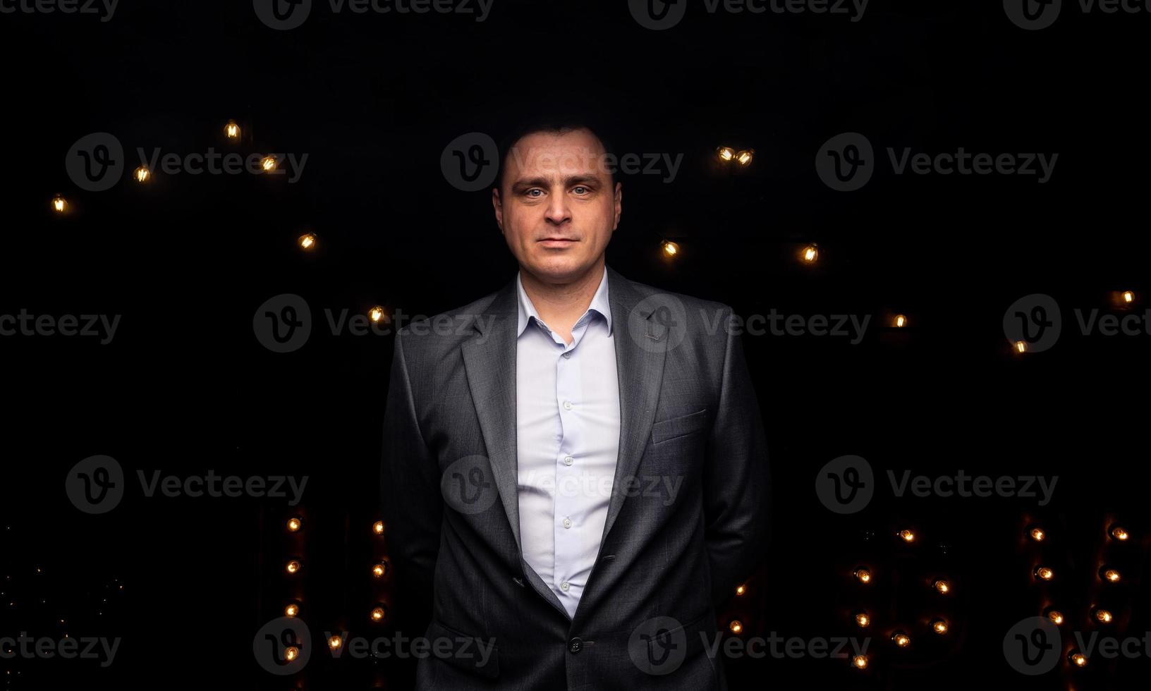 handsome businessman in a suit looks at the camera. photo