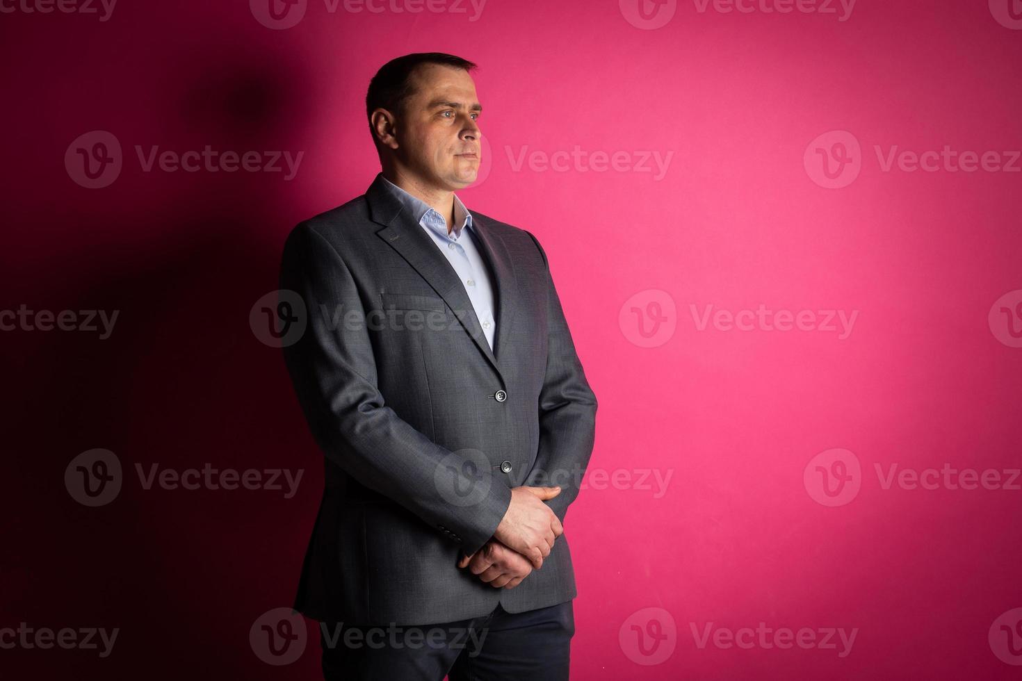 handsome businessman in a suit looks at the camera. photo