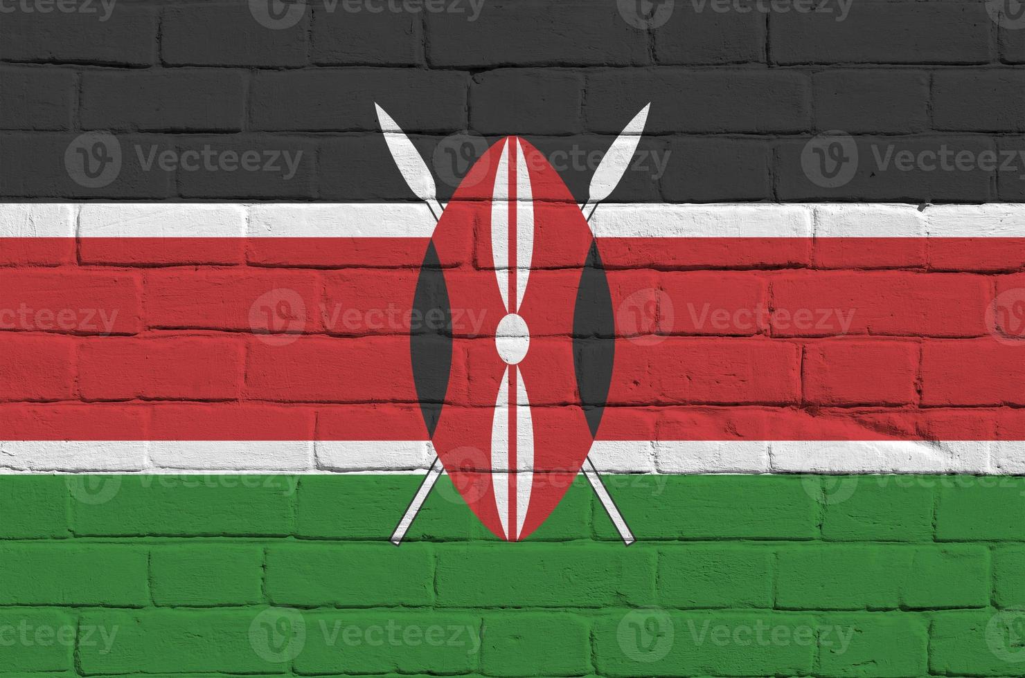 Kenya flag depicted in paint colors on old brick wall. Textured banner on big brick wall masonry background photo