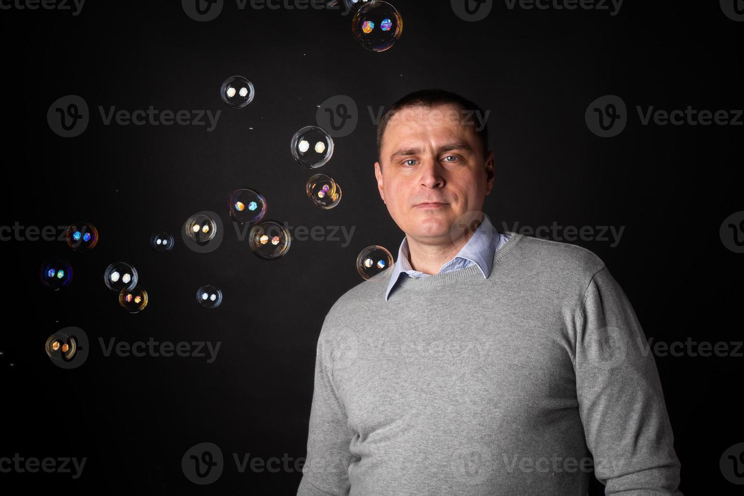 handsome businessman in a suit looks at the camera. photo