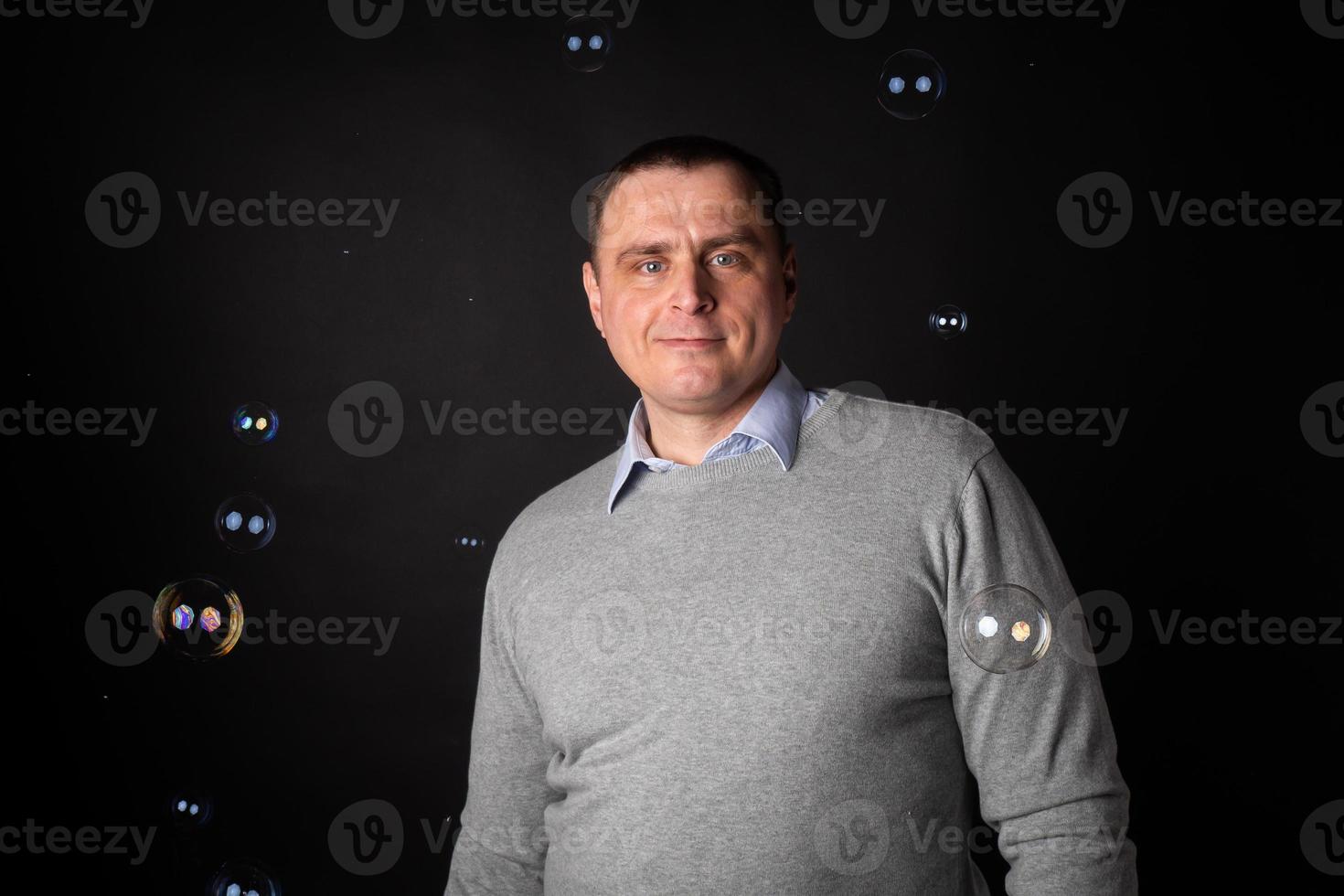 handsome businessman in a suit looks at the camera. photo