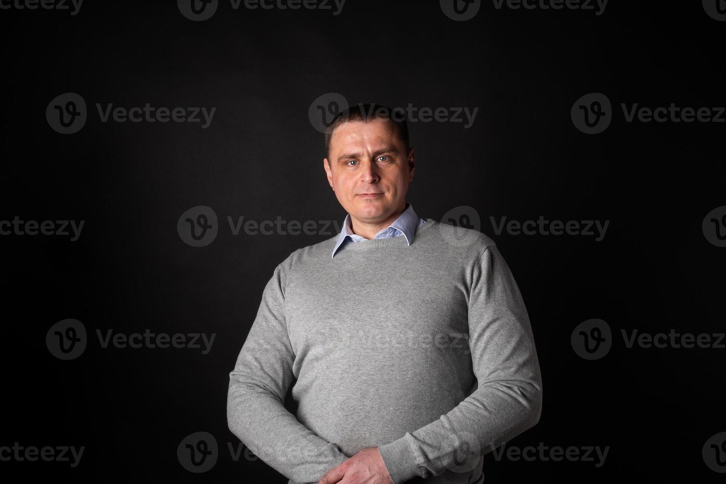 handsome businessman in a suit looks at the camera. photo