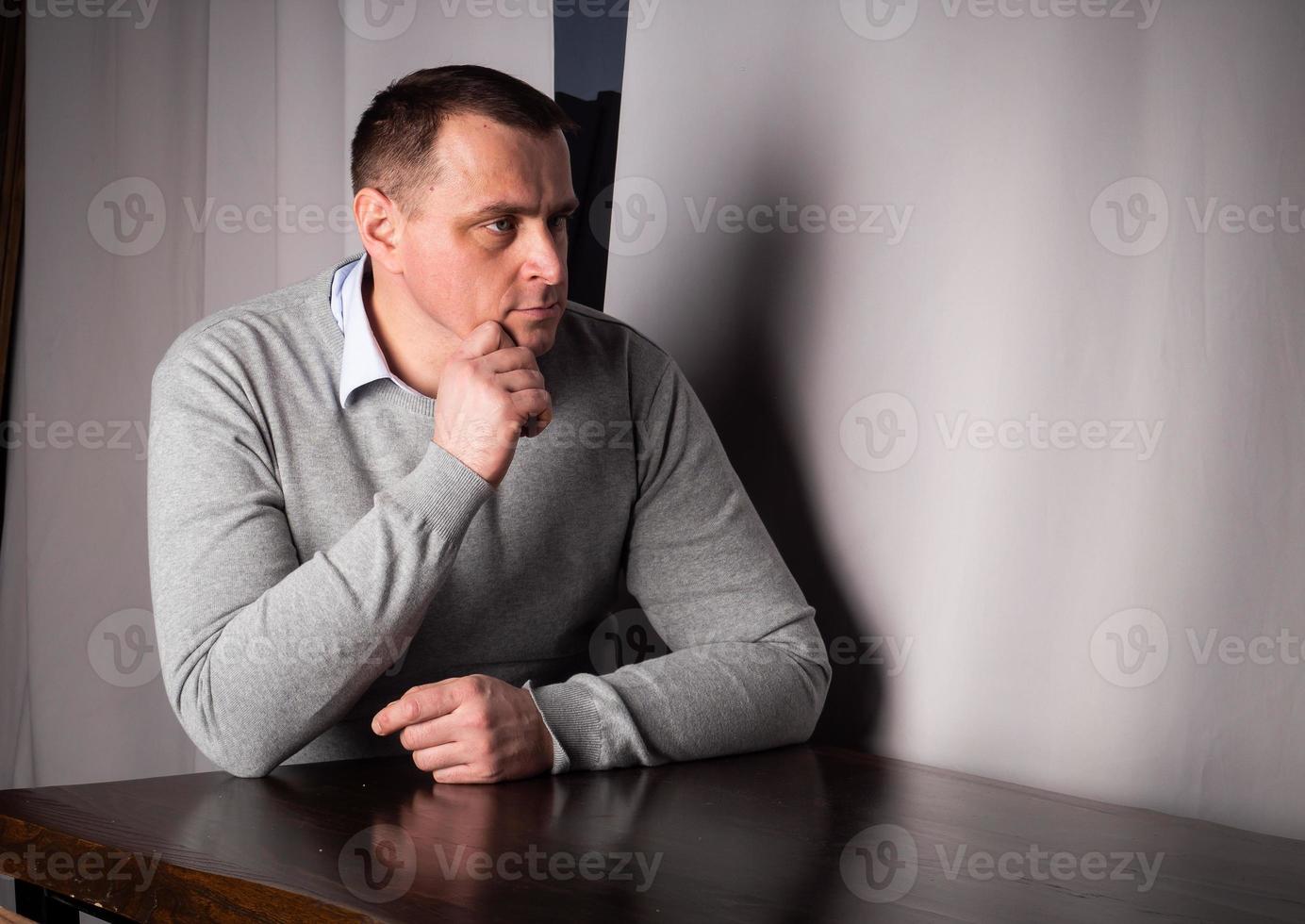 handsome man in a suit poses in an interior studio. photo