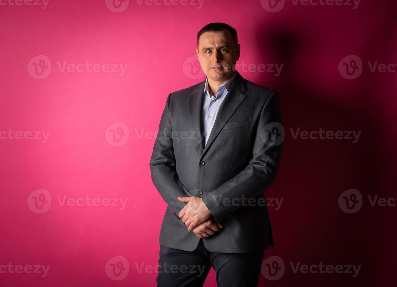 handsome businessman in a suit looks at the camera. photo