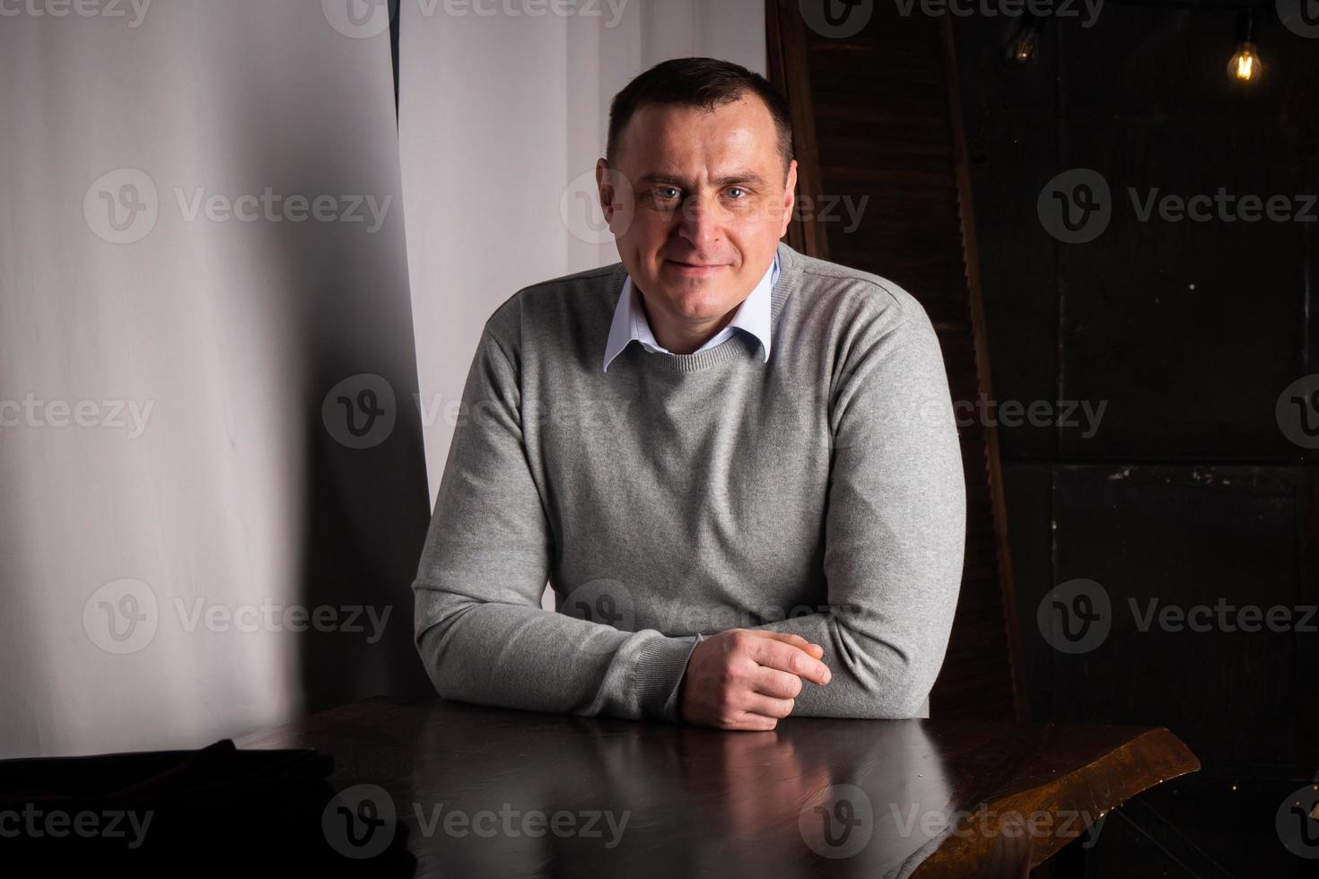 handsome man in a suit poses in an interior studio. photo