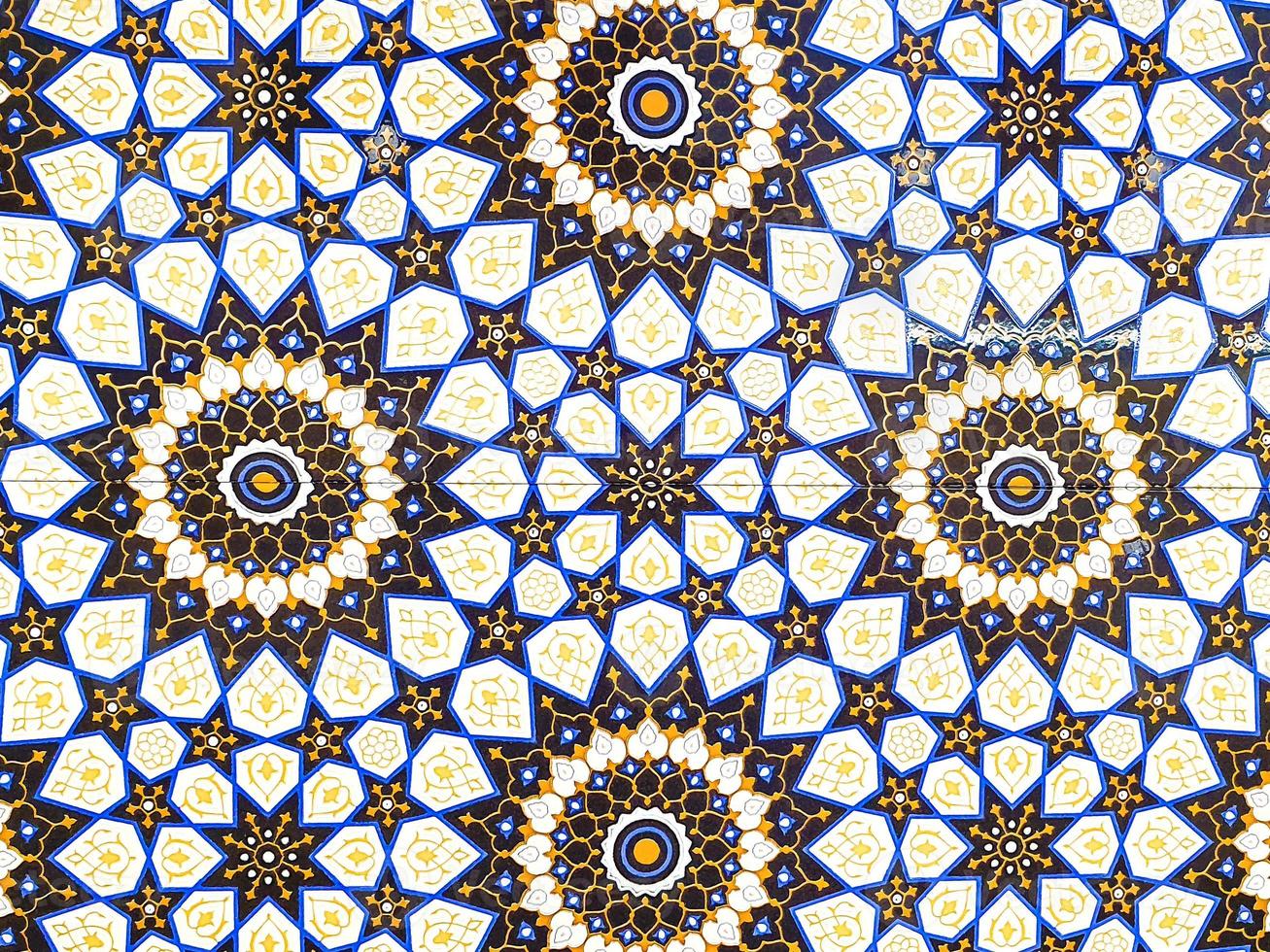 traditional Uzbek pattern on ceramic tile on wall of mosque Seamless old floral pattern Abstract background photo