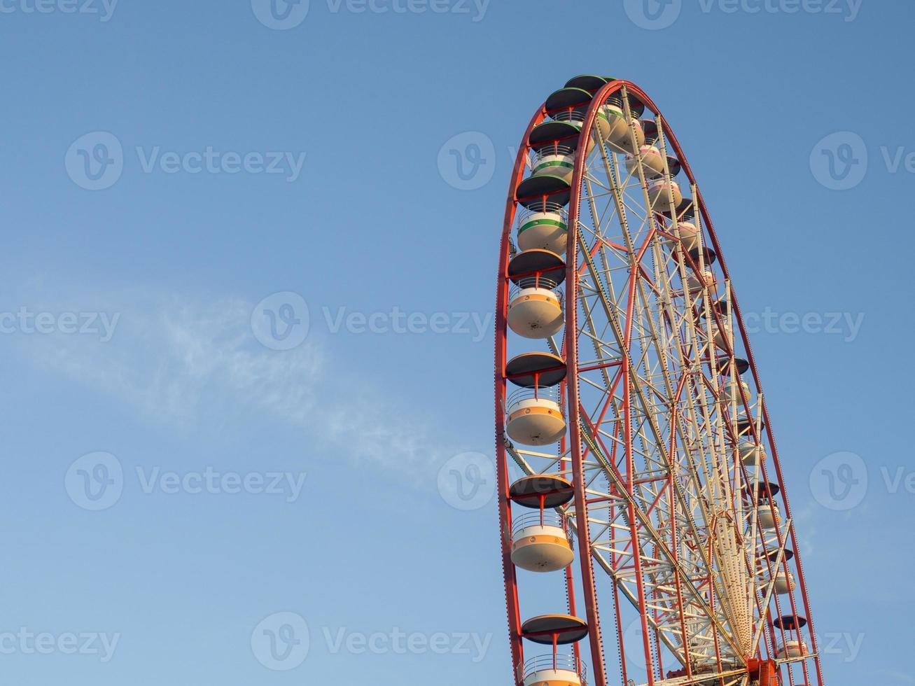 Ferris wheel against the sky. Amusement park on the sea. Rest zone. photo