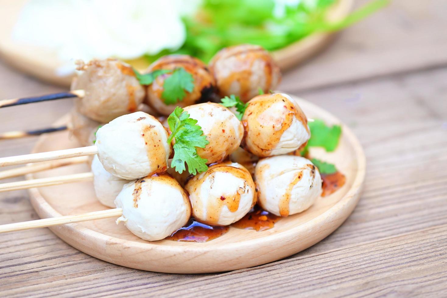 Meatballs on plate with with spicy sauce, Grilled meatball and pork ball, Meat ball on skewers and fresh coriander vegetables, Thai food Asian food Meat balls - pork balls photo