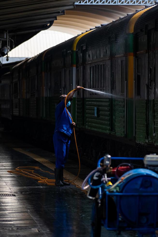 Bangkok, Thailand - September 24  A cleaner is cleaning a train at Hua Lamphong Station on September 24, 2022 in Bangkok, Thailand. photo