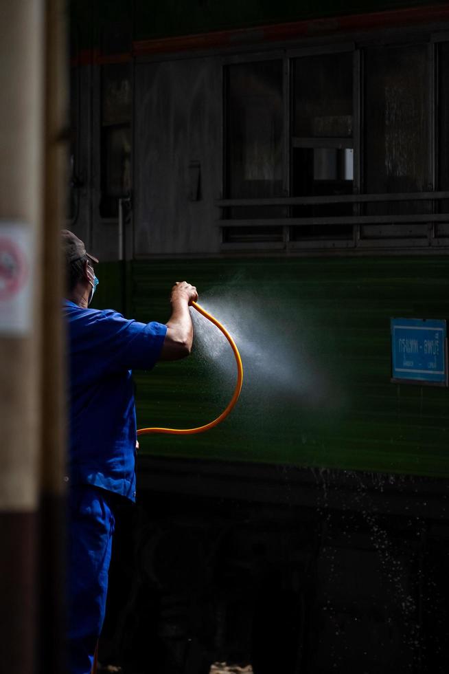 Bangkok, Thailand - September 24  A cleaner is cleaning a train at Hua Lamphong Station on September 24, 2022 in Bangkok, Thailand. photo