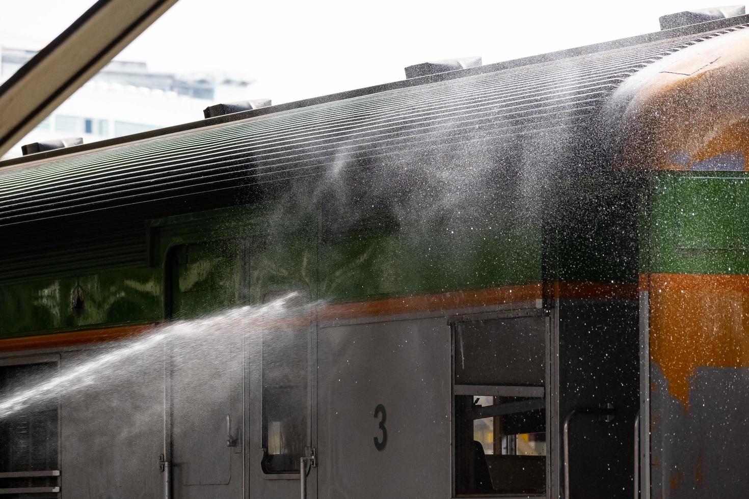 Bangkok, Thailand - September 24  A cleaner is cleaning a train at Hua Lamphong Station on September 24, 2022 in Bangkok, Thailand. photo