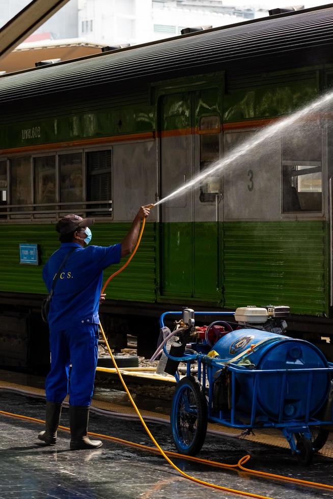 Bangkok, Thailand - September 24  A cleaner is cleaning a train at Hua Lamphong Station on September 24, 2022 in Bangkok, Thailand. photo