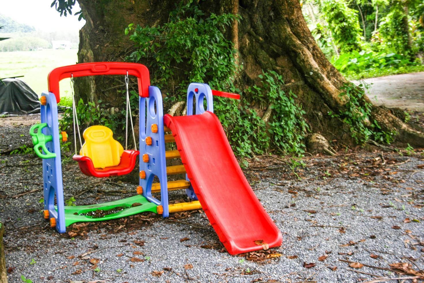 A brightly colored playground under the trees in the Thai countryside. photo