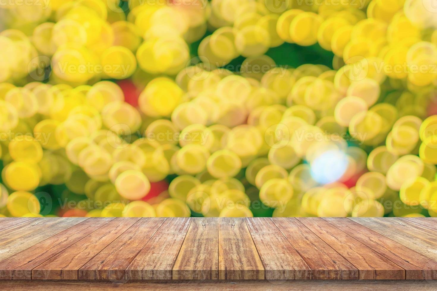 Empty wood table top with blur Christmas tree with bokeh light background photo